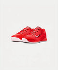 Red athletic shoes with white soles on a light gray background